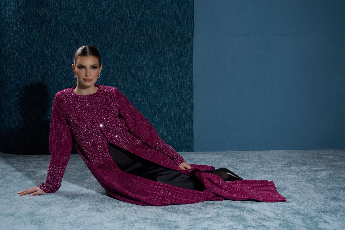 Hissa Line burgundy tweed abaya photographed against a blue backdrop